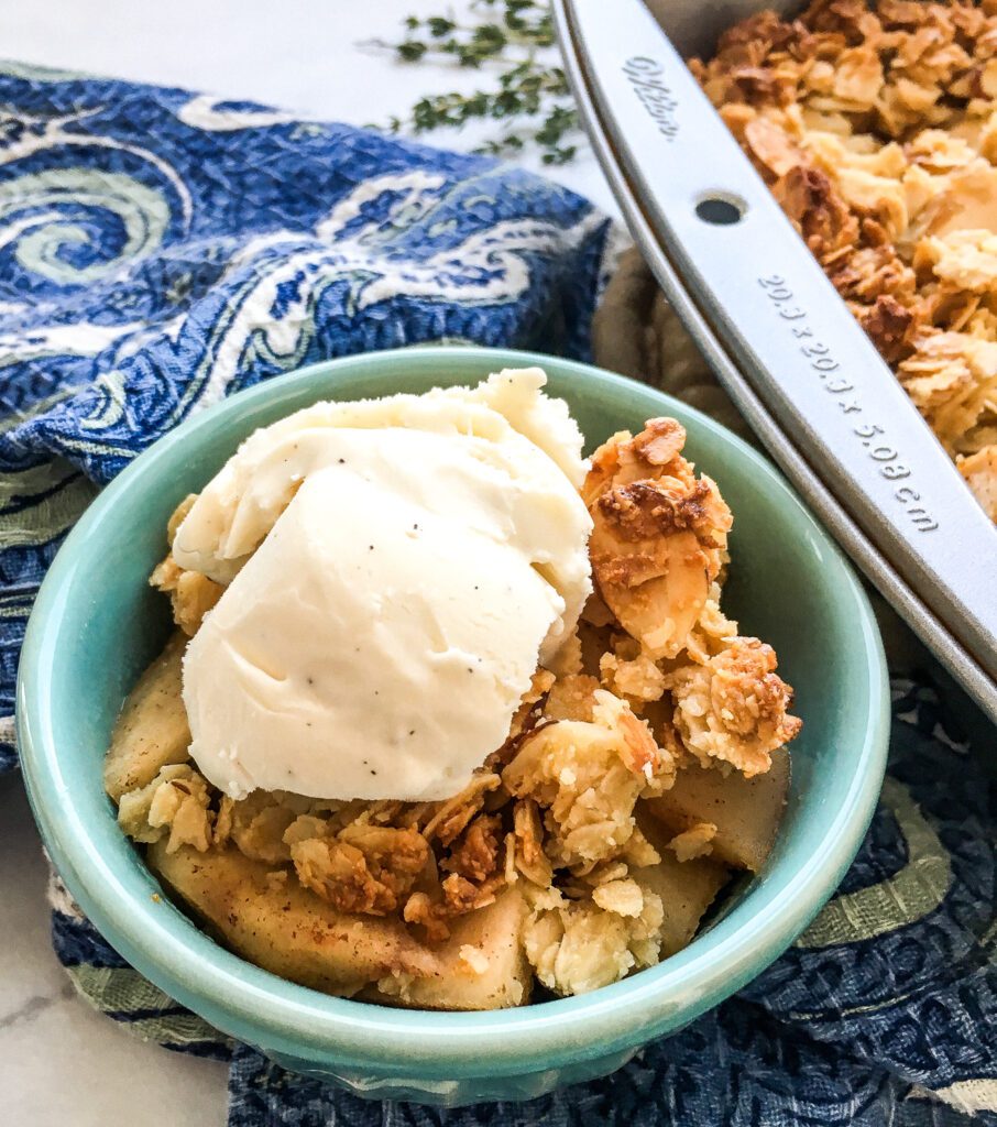 Picture of an apple crisp dessert with ice cream on top
