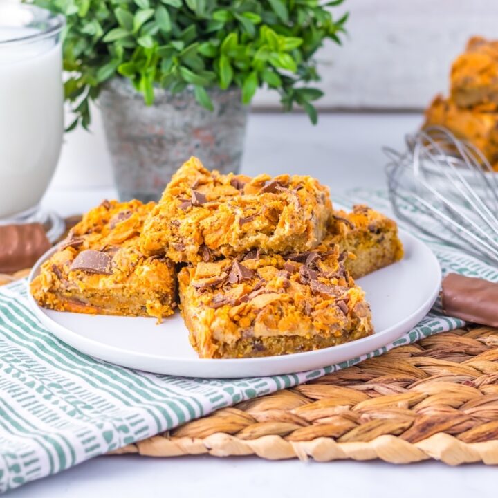 Stack of Butterfinger Cookie Bars in a plate