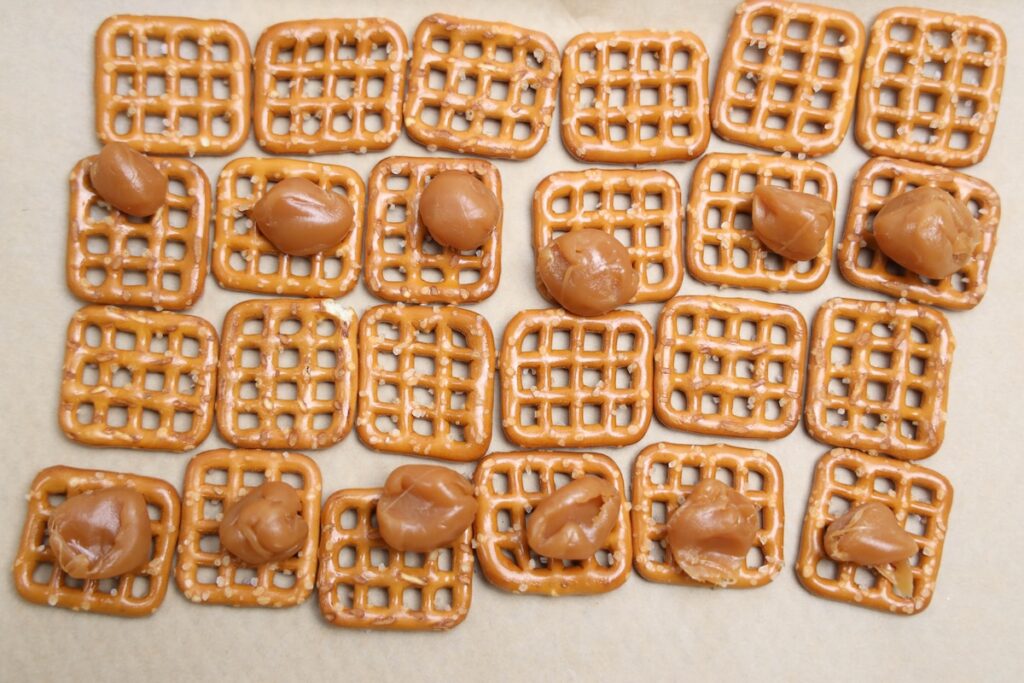Line of caramel pretzels in a parchment paper