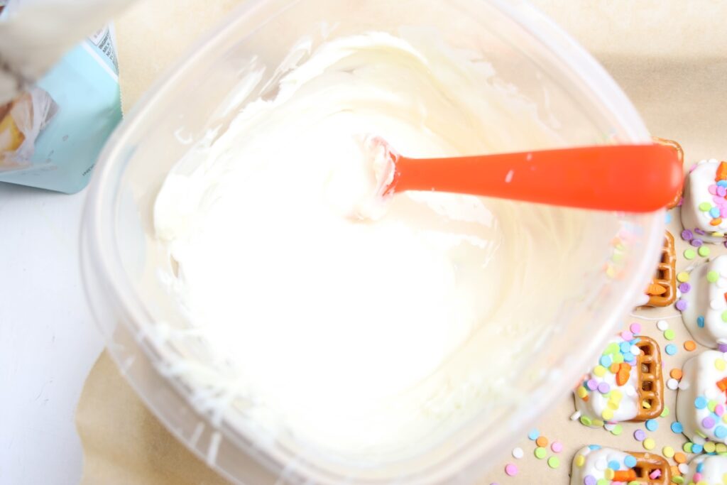 Melted white chocolate wafers in a clear container