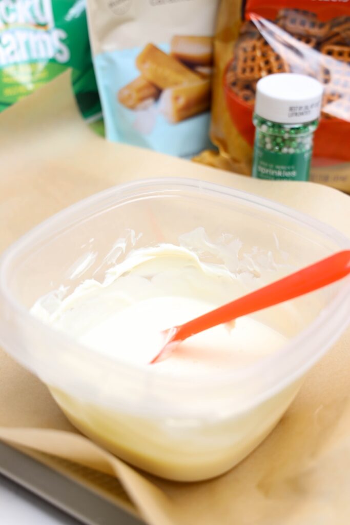 Melted white chocolate wafers in a clear container
