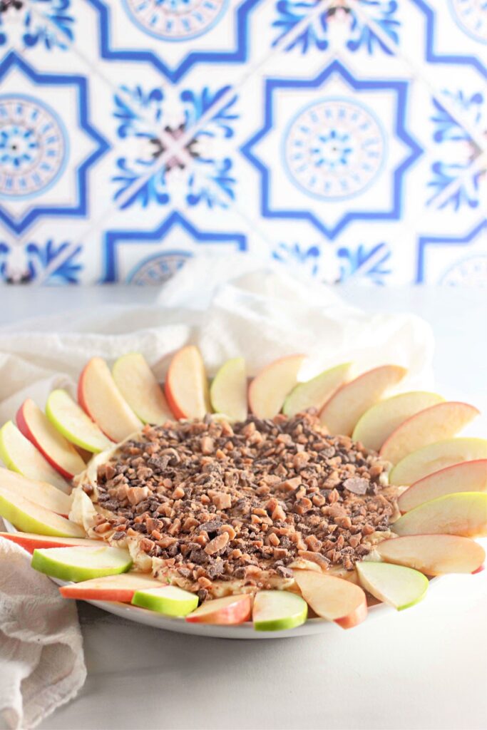 Toffee apple dip with apple slices around it