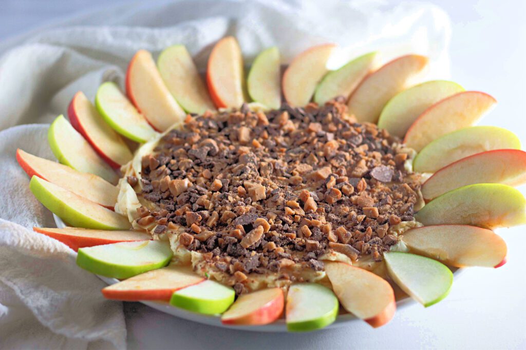 Toffee apple dip with apple slices around it