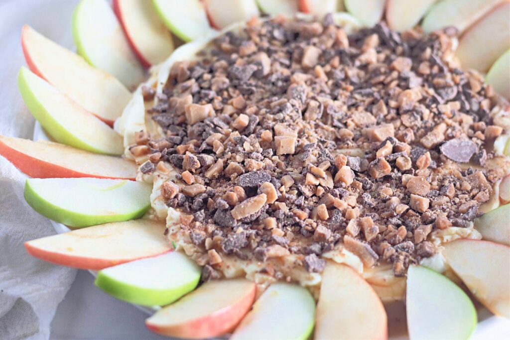 Toffee apple dip with apple slices around it