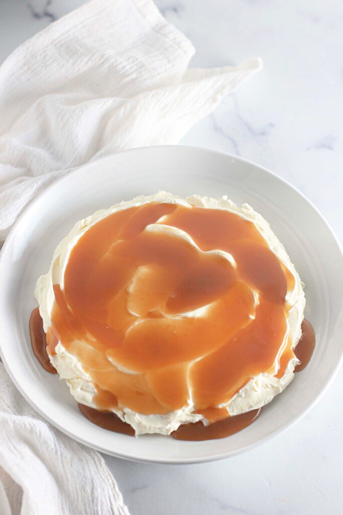 Toffee apple dip with cream cheese on top and caramel sauce