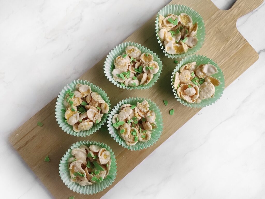 Cupcake cups in a board full of cereal cookies
