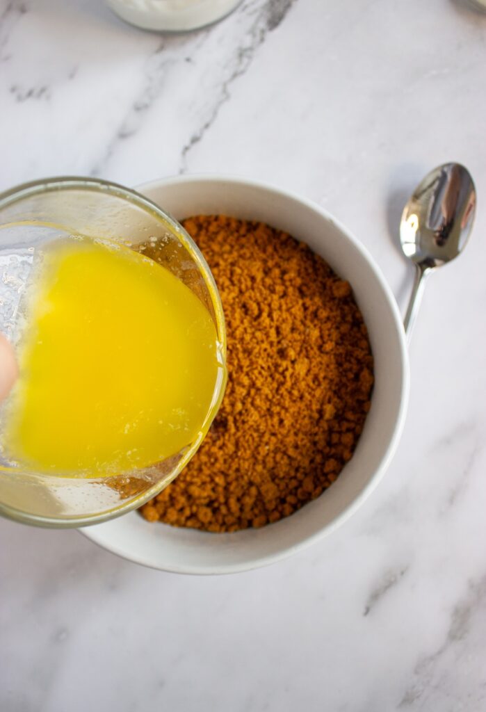 Biscoff crumbs in a bowl and melted butter