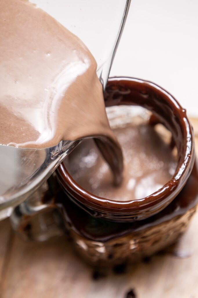 Pouring chocolate drink in a glass