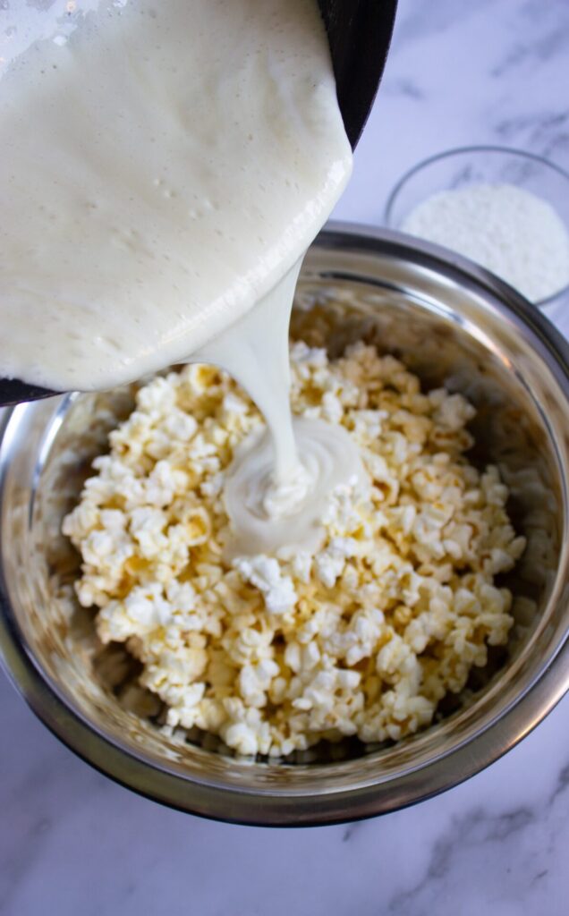 Adding melted butter and marshmallow to popcorn