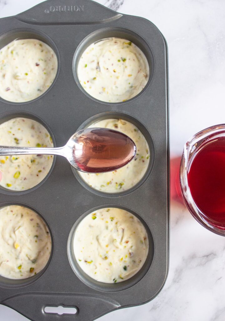 Adding a spoon of cranberry gelatin to mini cheesecakes