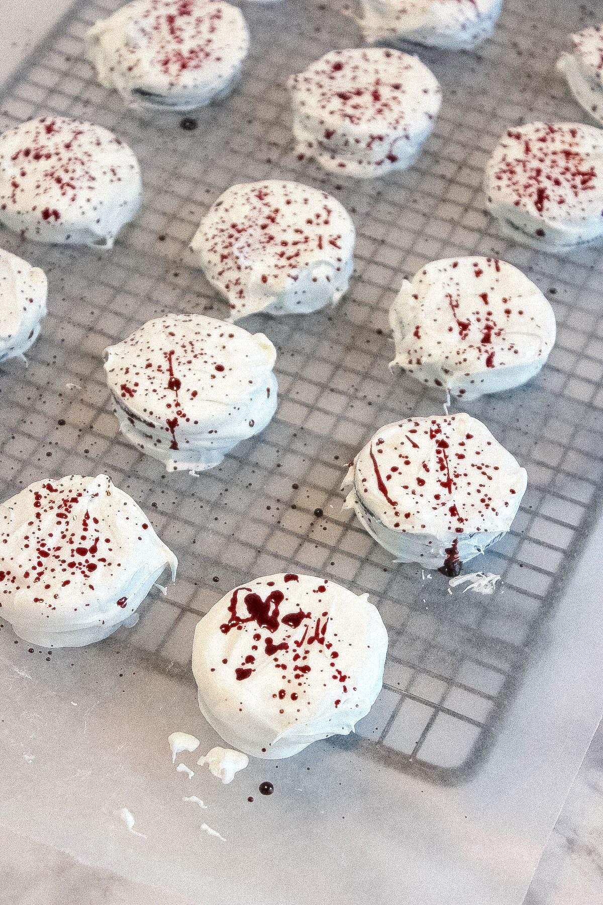 Oreos in a baking rack with red coloring splatter