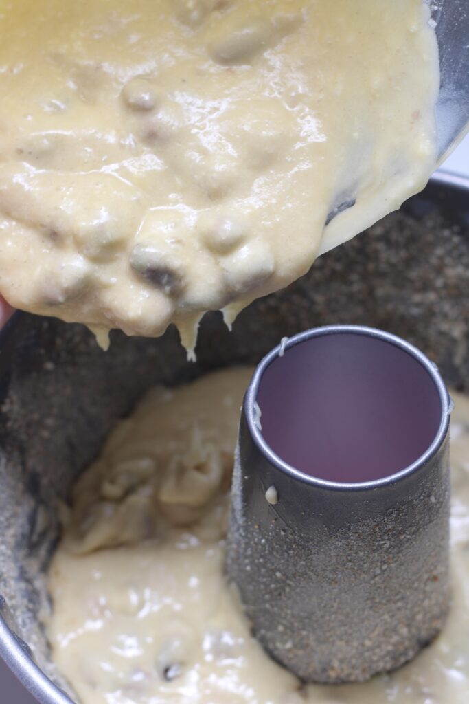 Pouring the mixed flour into the pistachio batter
