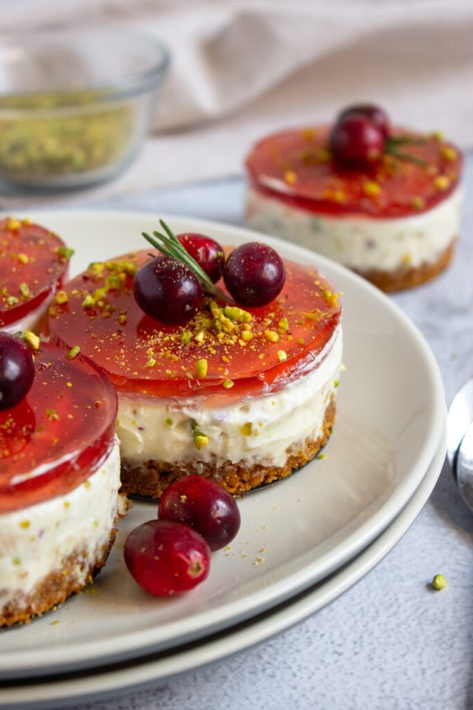 Pistachio cranberry no-bake mini cheesecakes topped with cranberries