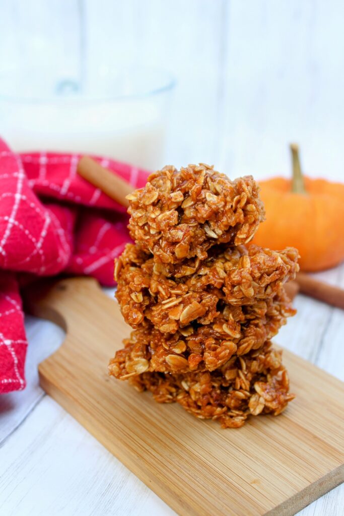 Stack of pumpkin pudding no bake cookies in a wooden chopping board