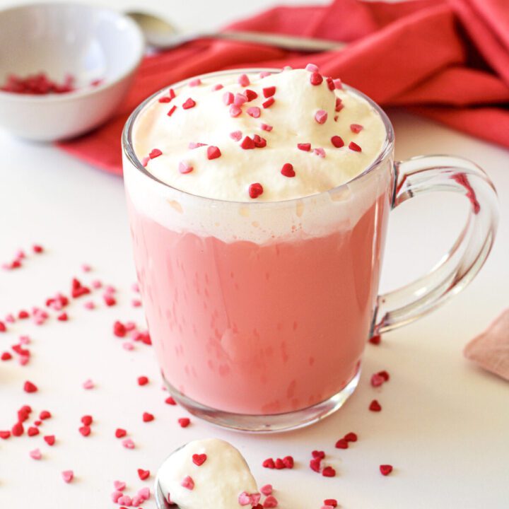 Red velvet hot chocolate with whipped cream and sprinkles