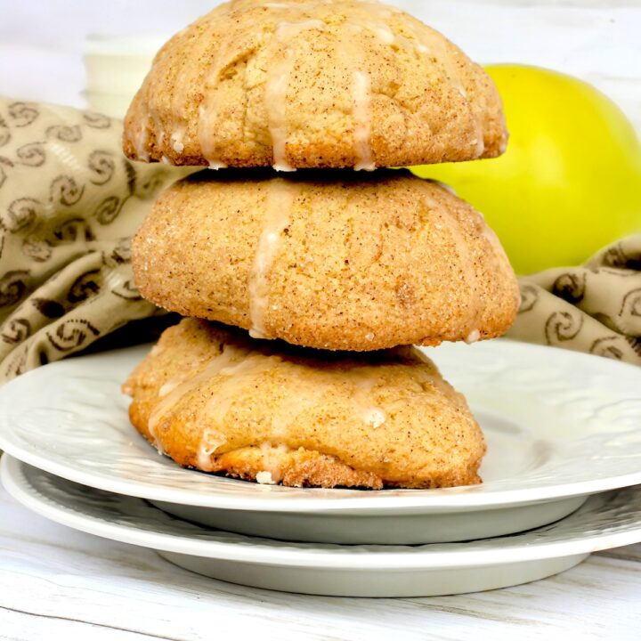 Three salted caramel apple cider cookies stacked with glaze