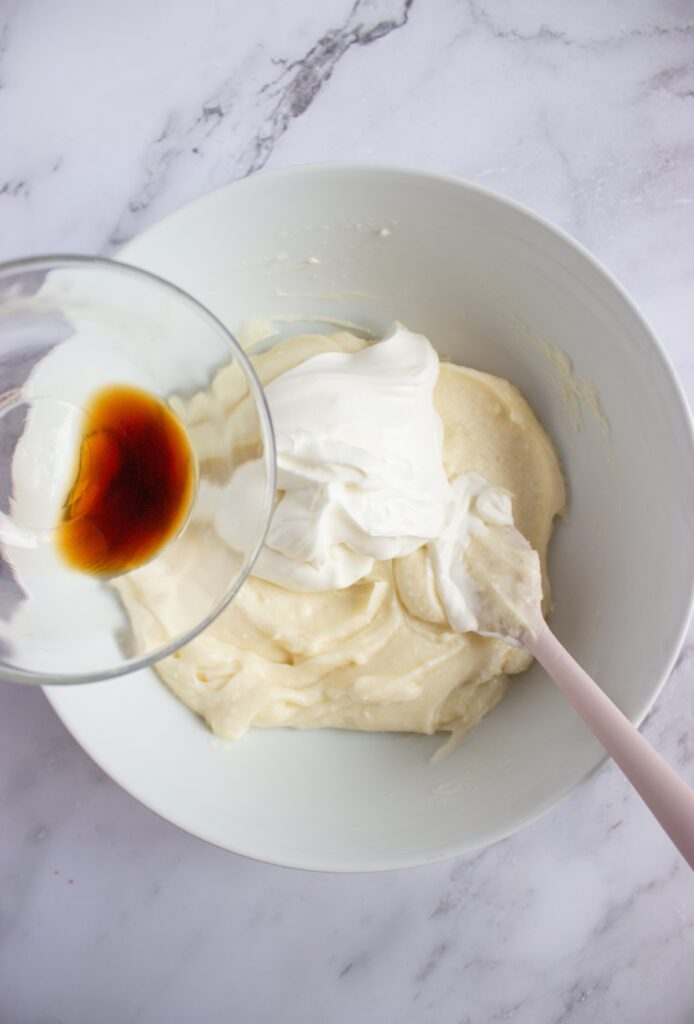 Adding vanilla extract to the creemcheese mix
