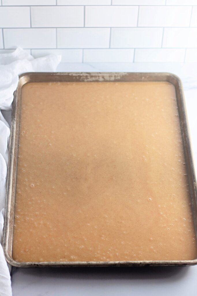 sliced caramel apple sheet cake with the batter