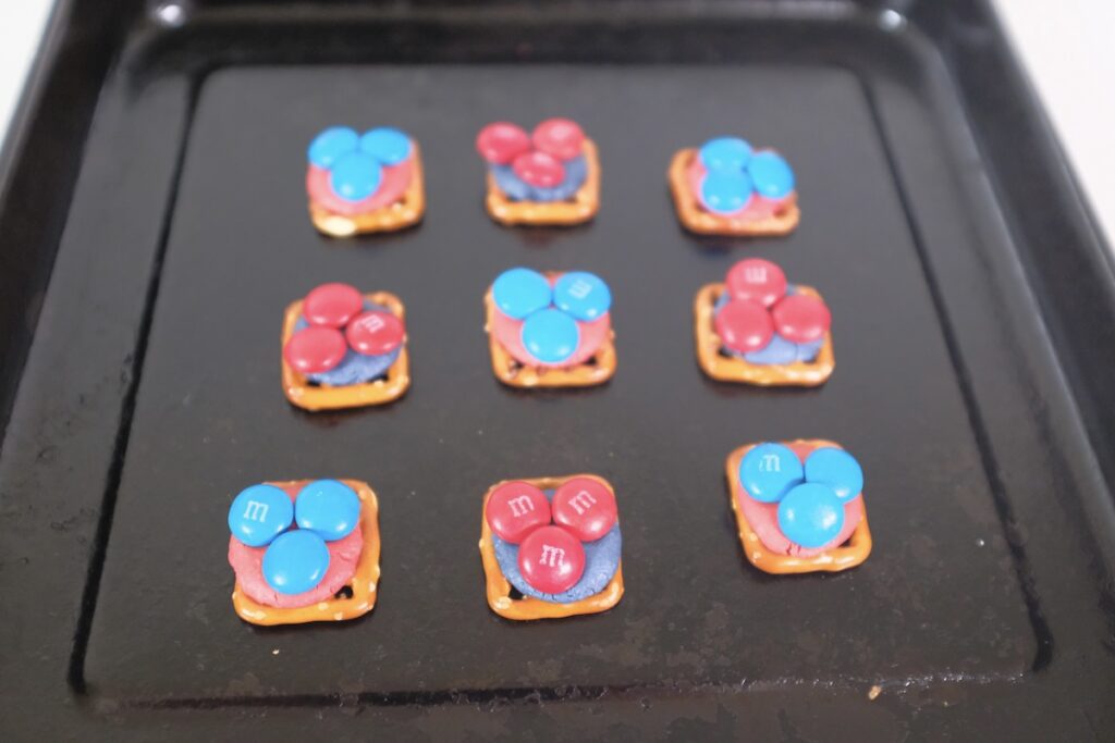 adding more candies to the pretzels