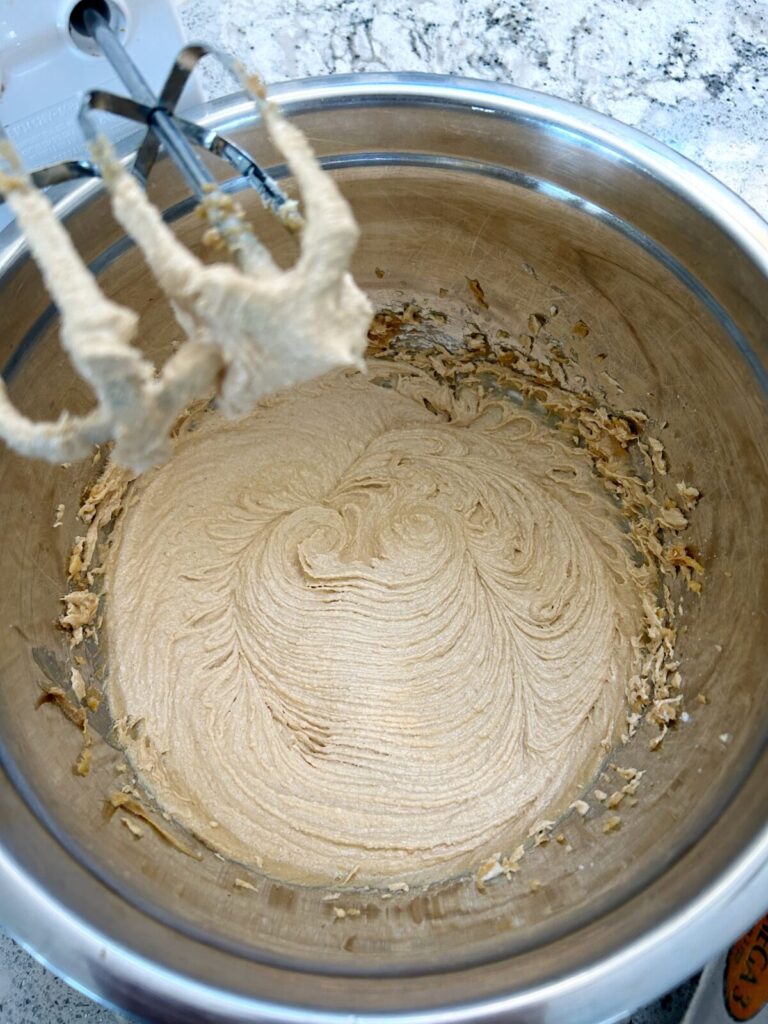 mixing butter, peanut butter, vanilla and sugar