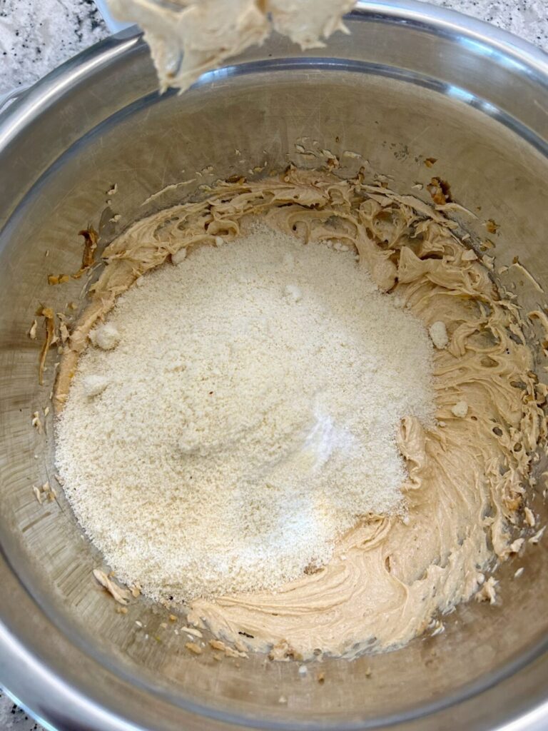 adding dry ingredients to the cookie mixture