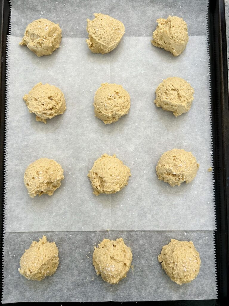 balls of cookie dough in the parchment paper