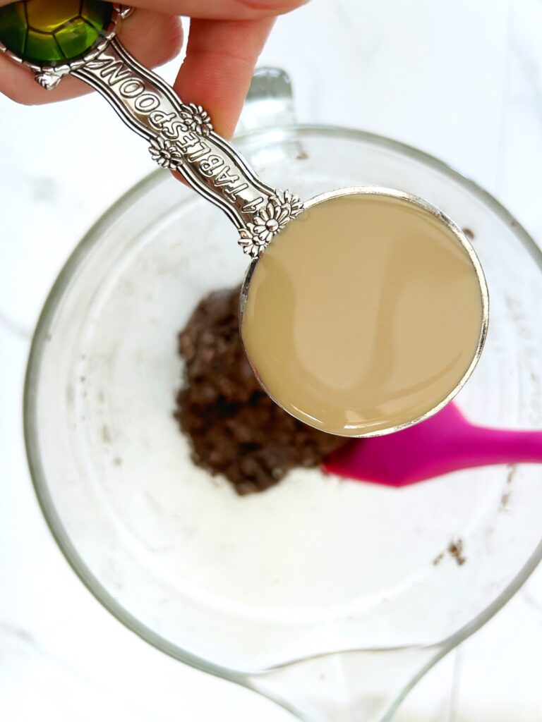 adding a cup of baileys to oreo mixture