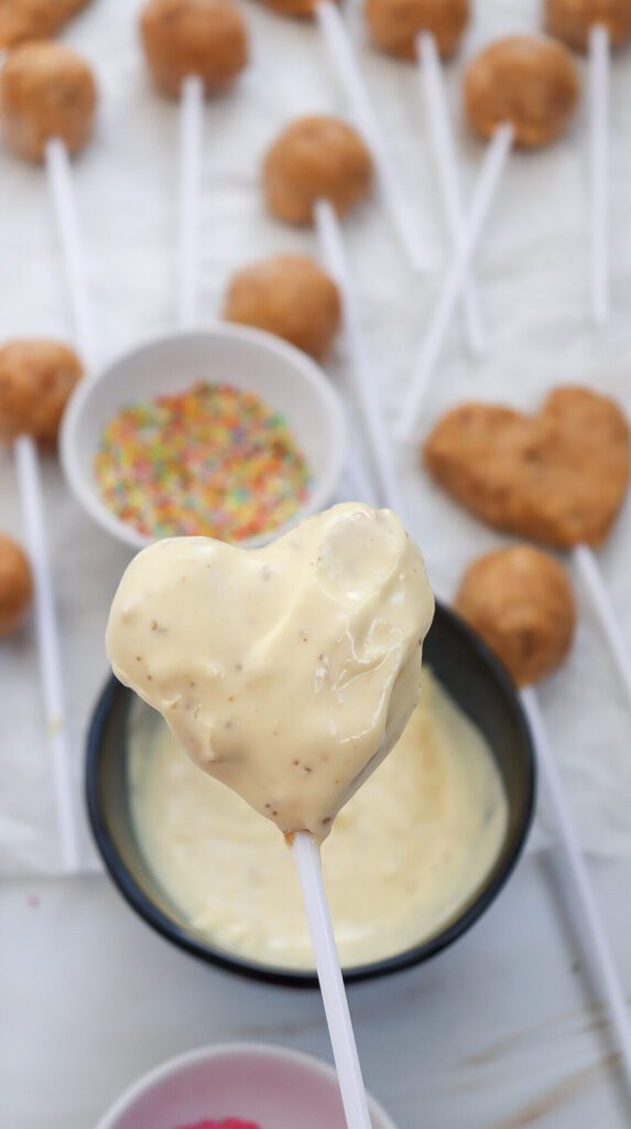 heart shaped cake pops in a stick coated with white chocolate