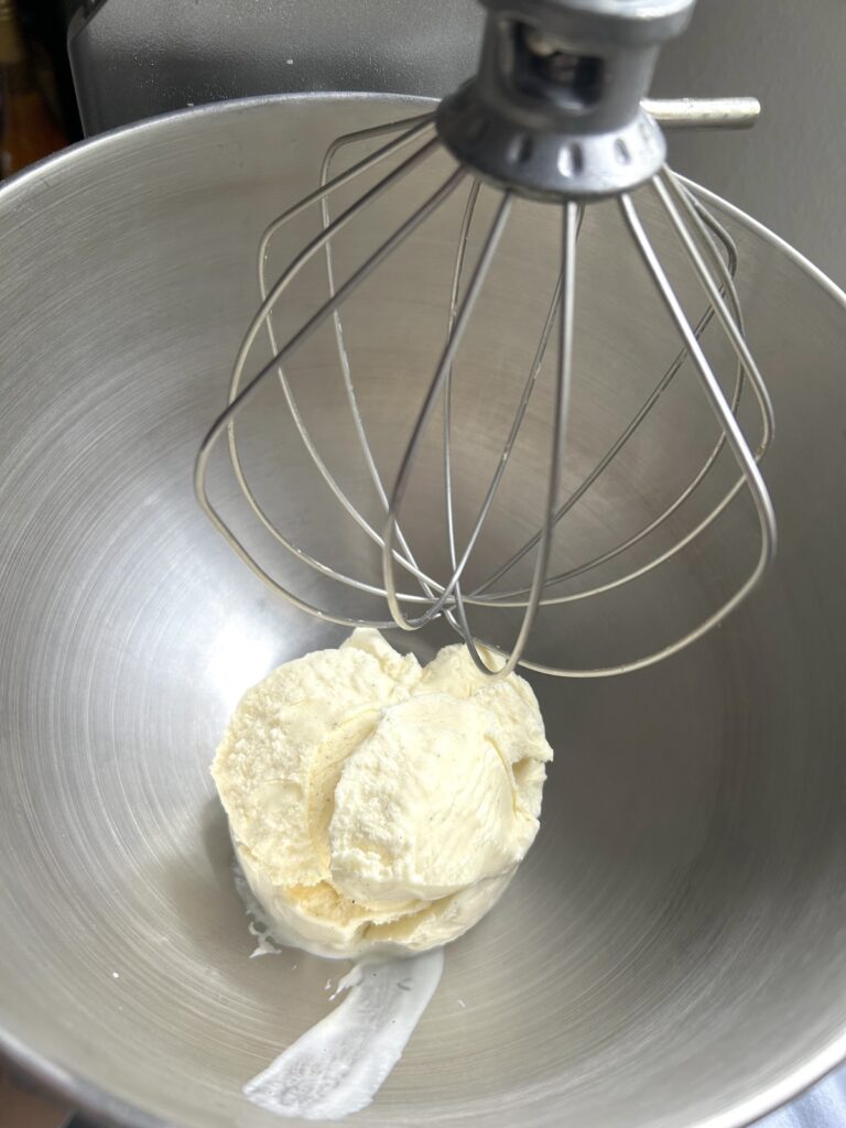 frozen ice cream inside a mixer bowl
