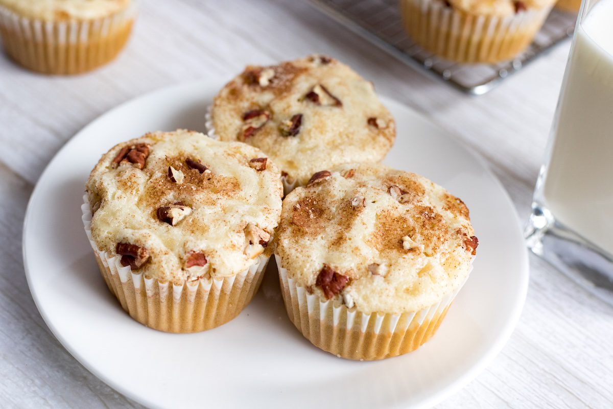 three cinnamon pecan cream cheese muffins in a plate