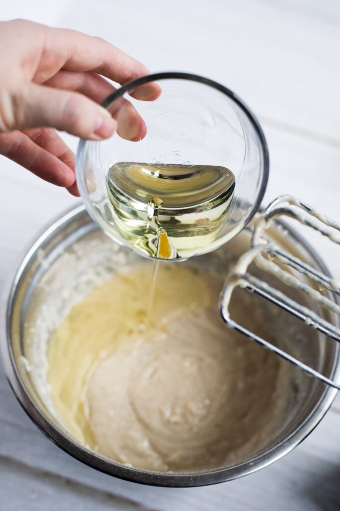 water, oil, vinegar, and vanilla extract in a bowl