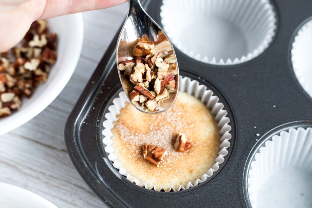 adding chopped pecans to the muffin batter