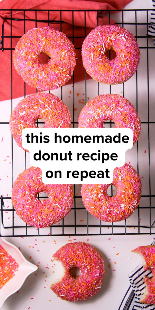 an overhead shot of sprinkle donuts on a cooling rack with text overlay that says this homemade donut recipe on repeat