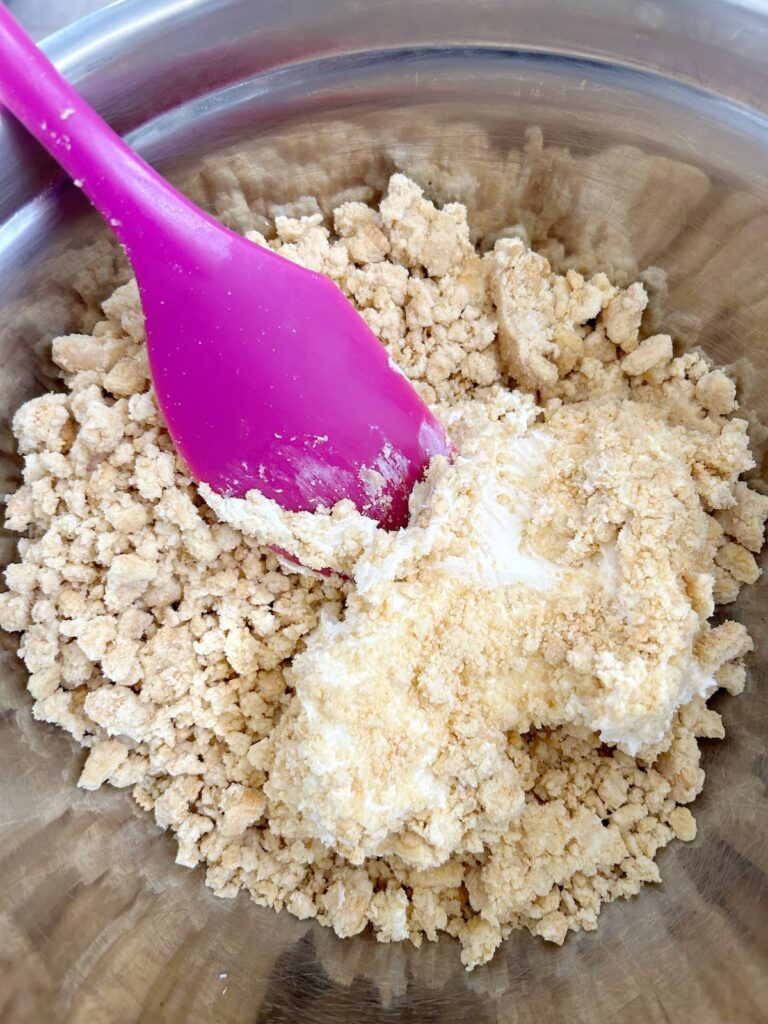 mixed cream cheese and pulverized oreos in a bowl