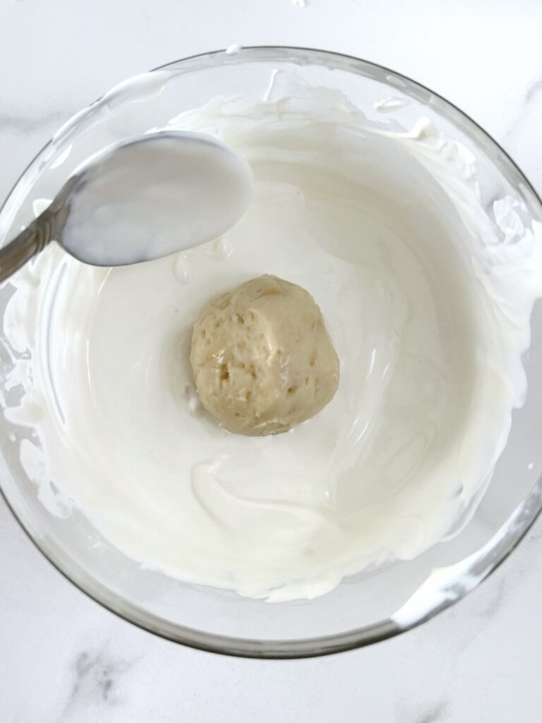 dipping oreo balls into the melted chocolate