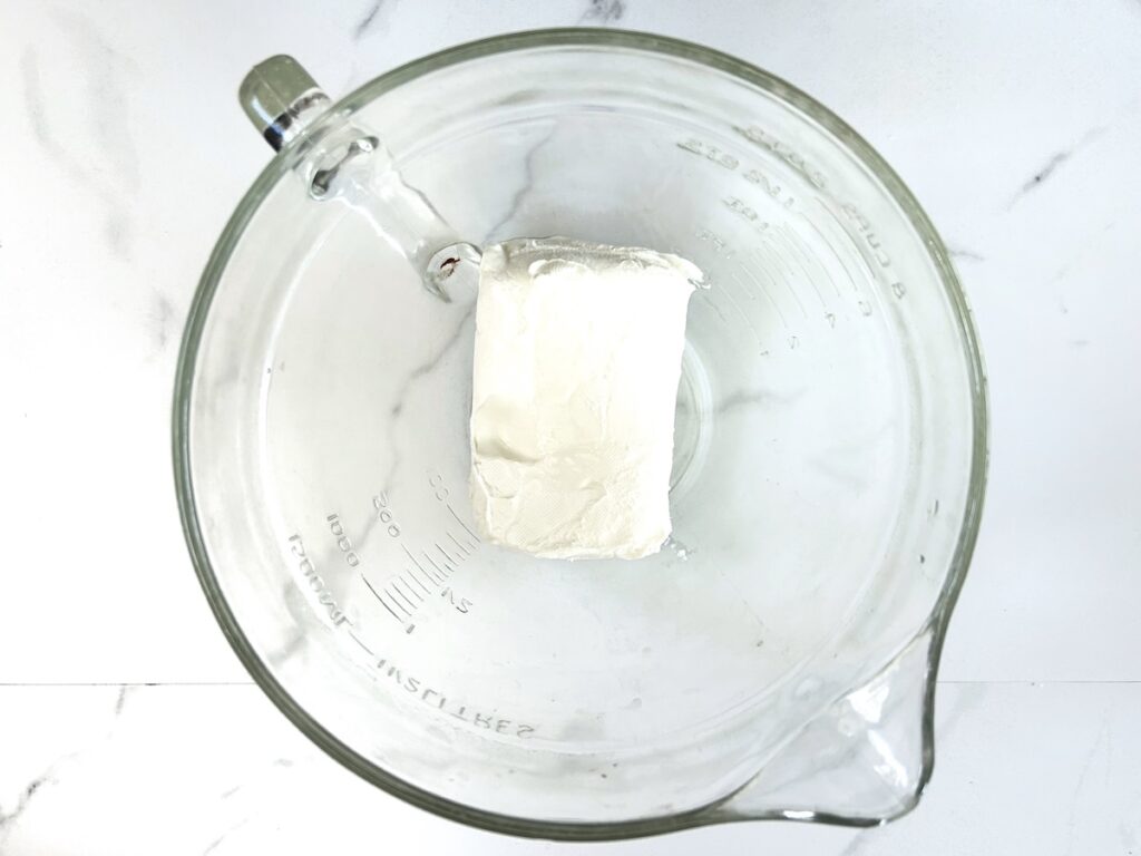 block of cream cheese in a bowl