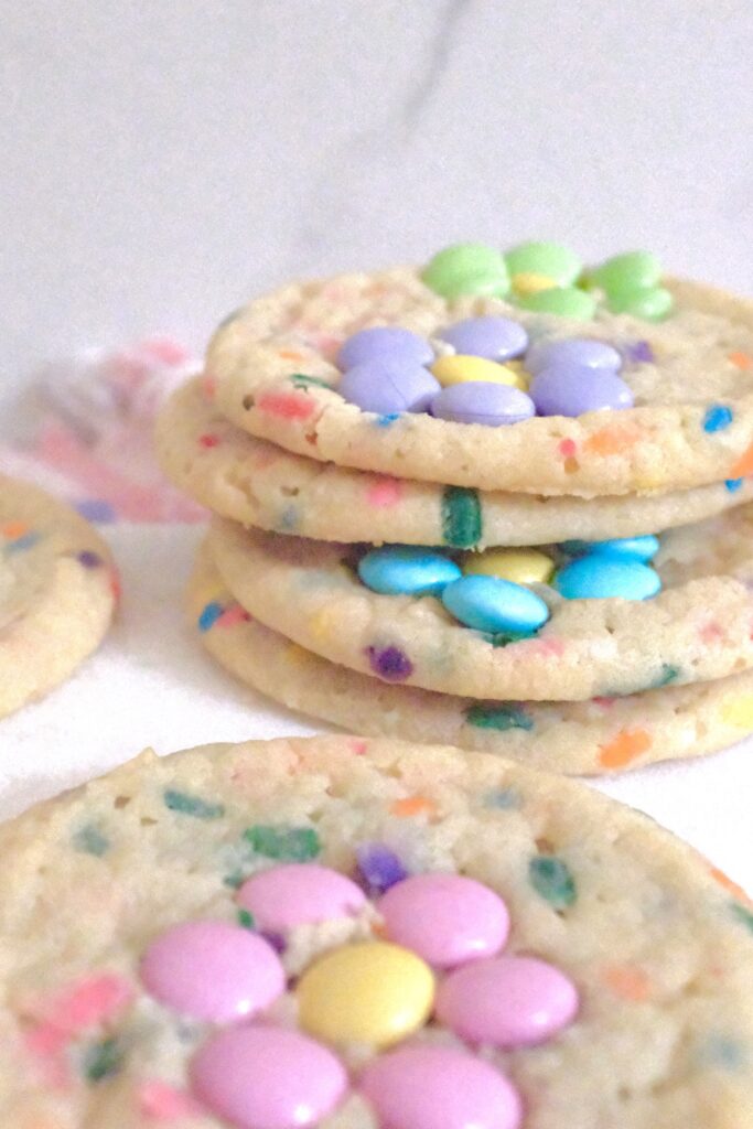 stack of sugar cookies with m&ms as flowers as its topping