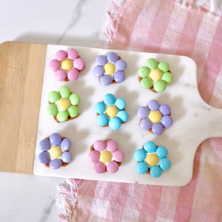 spring flower pretzels laid out in a wooden chopping board