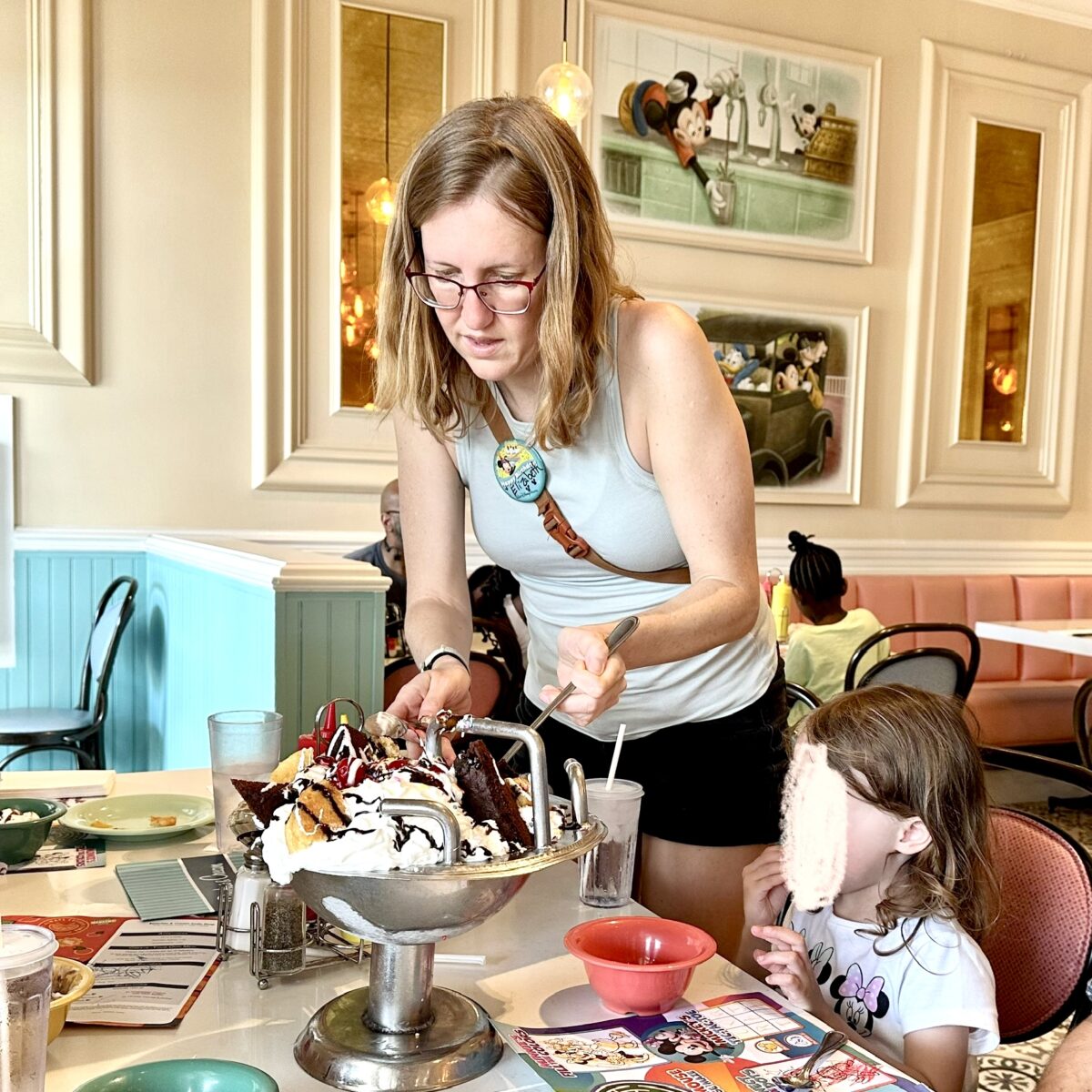 girl scooping out of a kitchen sink ice cream at disney
