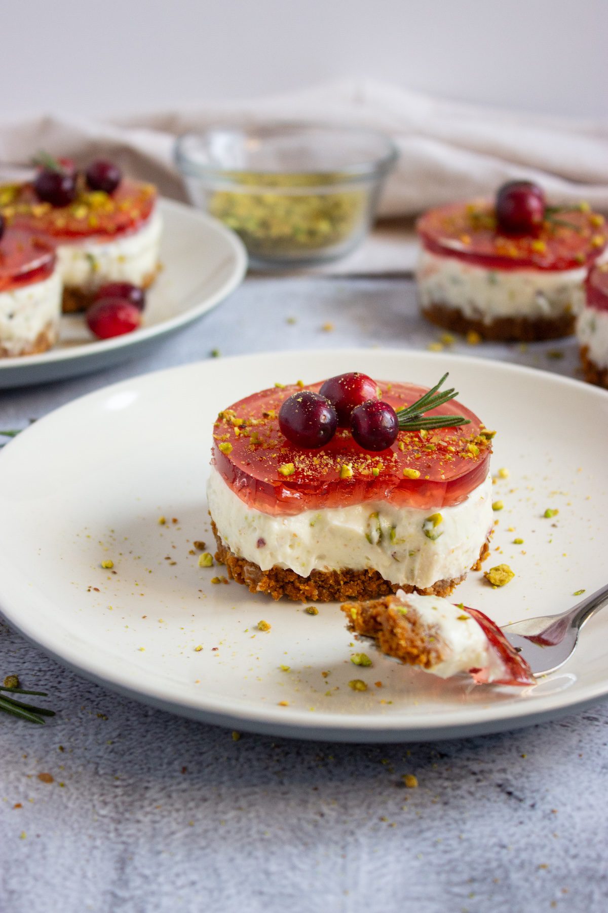Plate full of pistachio cranberry no-bake mini cheesecakes