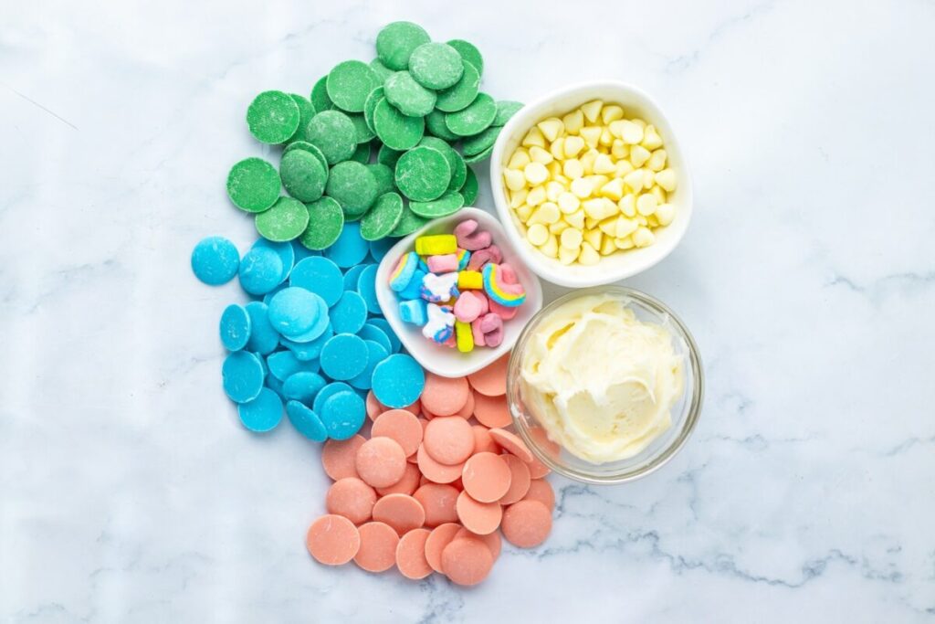 ingredients laid out to make lucky charm fudge (candy melts, white chocolate, lucky charms)