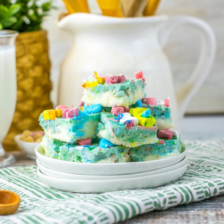 a plate of lucky charm fudge with kitchen utensils in the background
