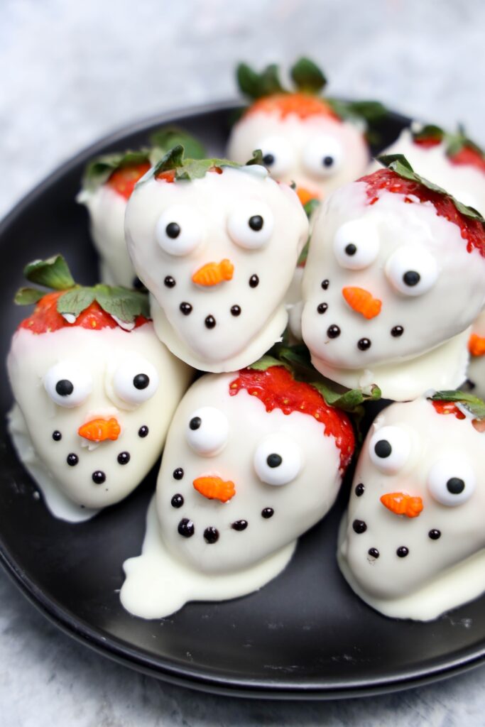 strawberries covered in white chocolate to look like snowmen