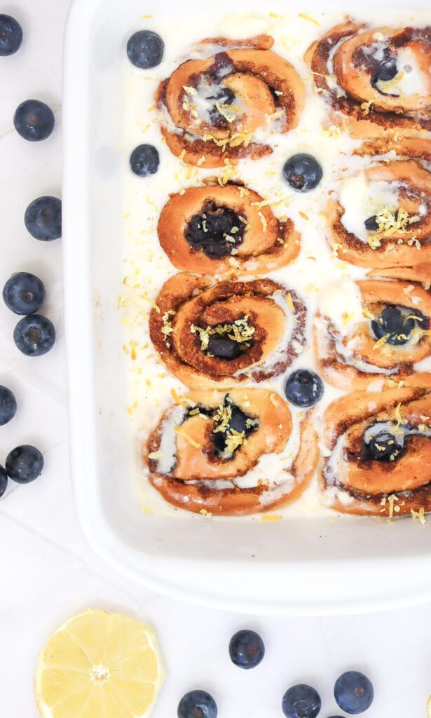 lemon blueberry cinnamon rolls in a white baking dish