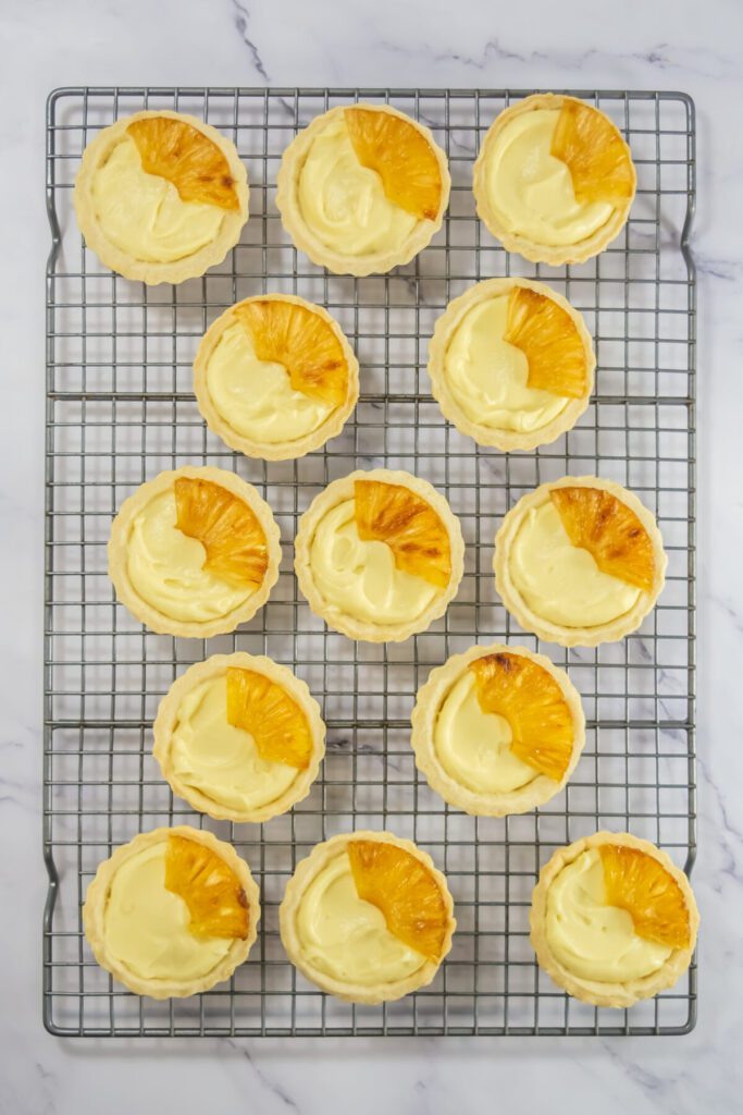 pina colada mini tarts on a baking cooling rack