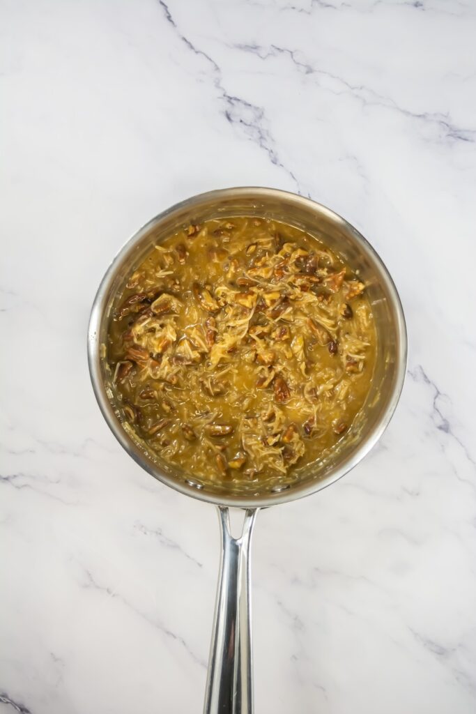 A mixing bowl with whipped chocolate buttercream frosting, smooth and fluffy with swirled peaks