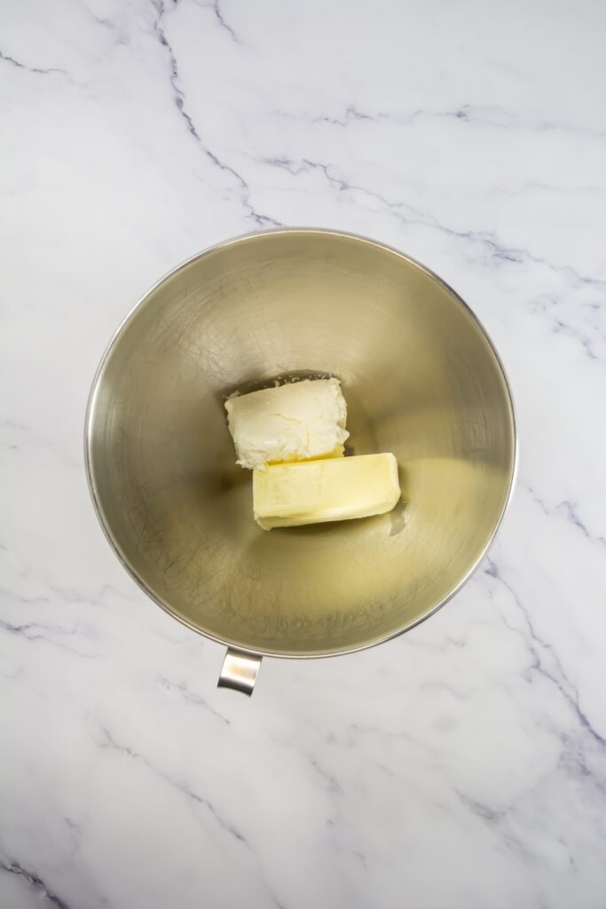 Mixing bowl with softened butter and cream cheese, ready to be combined for the frosting base