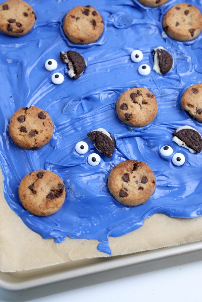 Added mini chocolate chip cookies to the tray of blue candy bark, making it look like Cookie Monsters are munching on cookies