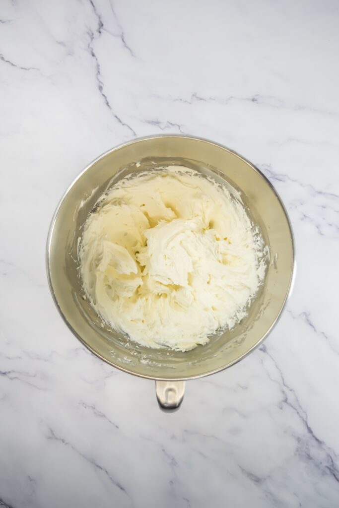 Creamy, fluffy white frosting fully mixed in a bowl, ready for spreading or piping