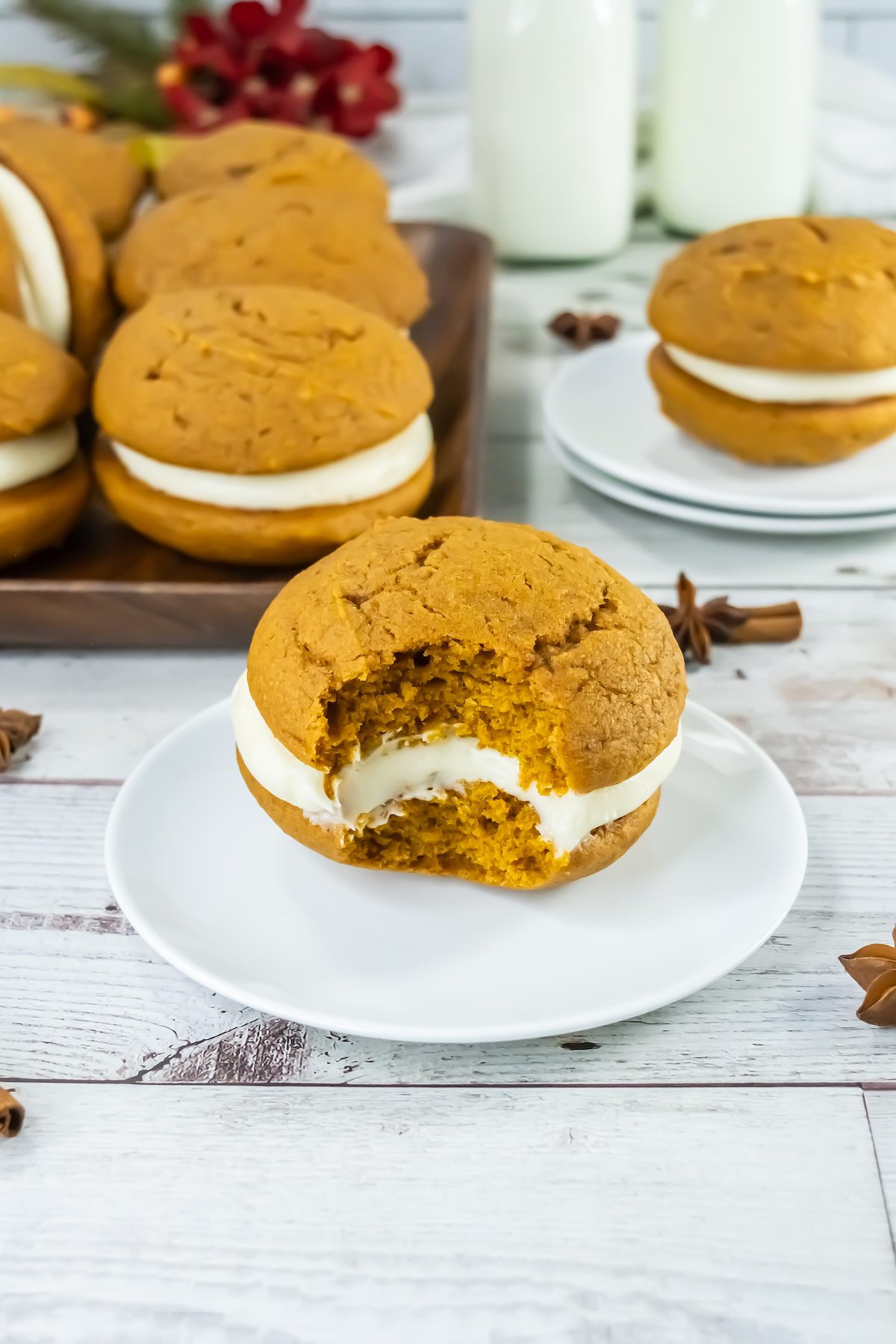 pumpkin whoopie pies on a plate with a bite taken out of it